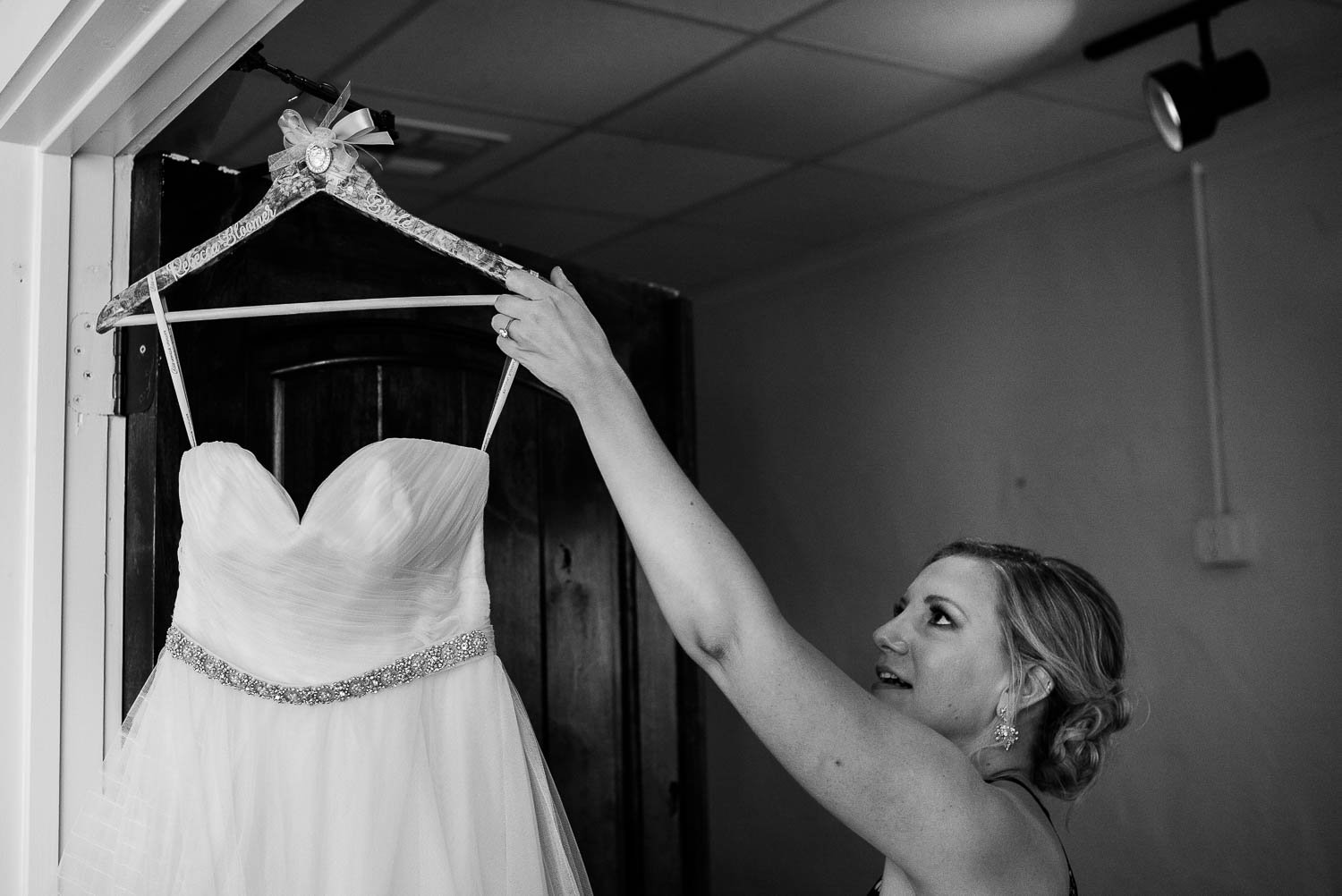 Rebecca the bride lifts her dress of the hanger at Bell Tower on 34th Houston-Leica wedding photographer-Philip Thomas Photography