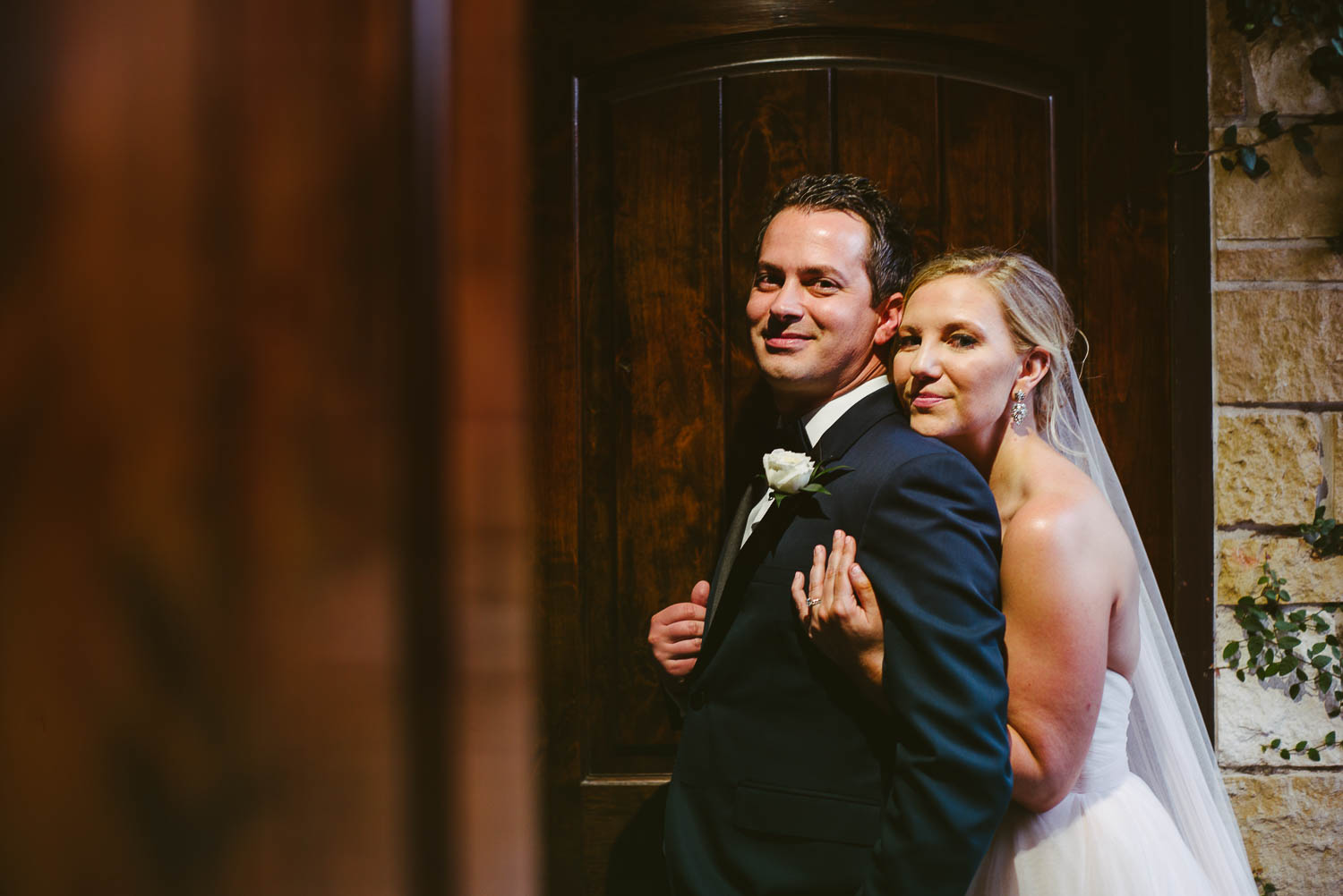 Couple with one light overhead in a doorframe pose Bell Tower on 34th Houston-Leica wedding photographer-Philip Thomas Photography