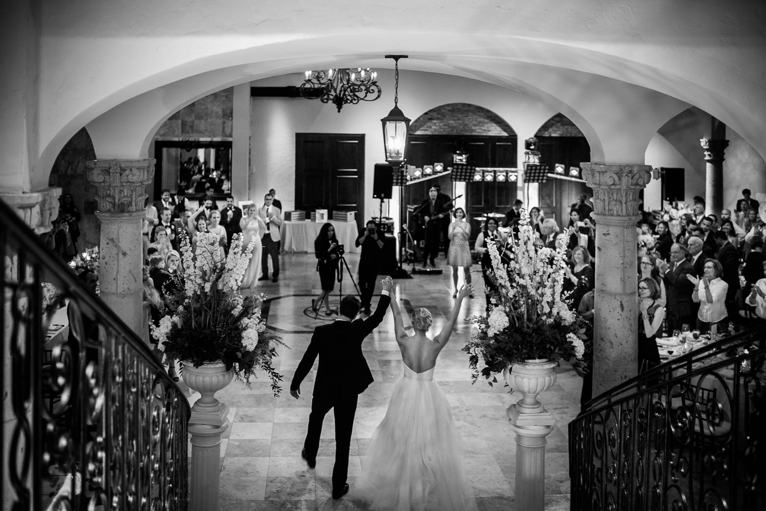 Arms raised as family and friends greet the couple wedding reception Bell Tower on 34th Houston-Leica wedding photographer-Philip Thomas Photography