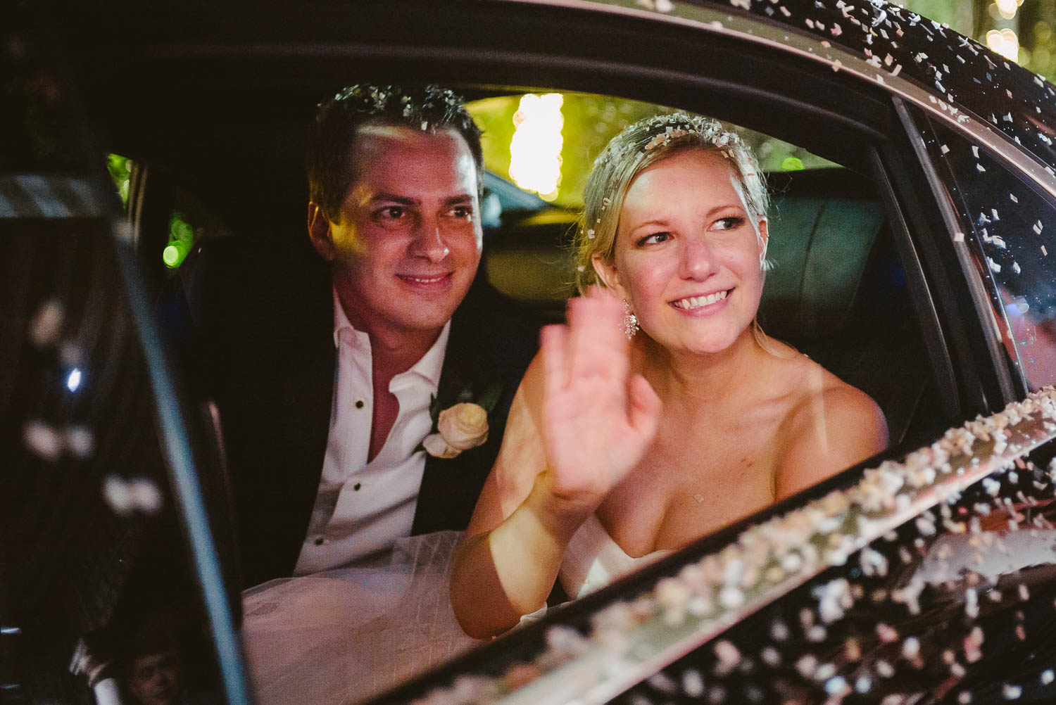 Couple wave goodbye in antique car departure -Bell Tower on 34th Houston-Leica wedding photographer-Philip Thomas Photography