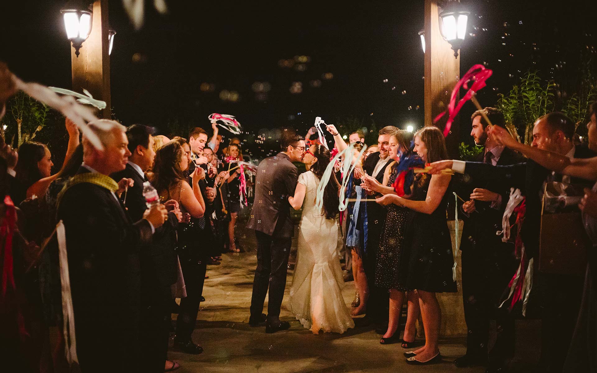 Couple depart reception with bubbles surrounded by friends and family Pecan Springs Brookshire Texas Leica M weddding photographer Philip Thomas