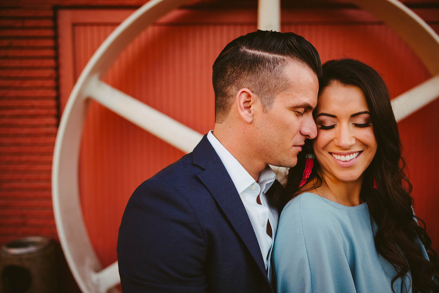 A large wagon wheel behind Havana Hotel Downtown San Antonio Engagement photos-06