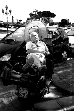 Italy - a man naps on a bike