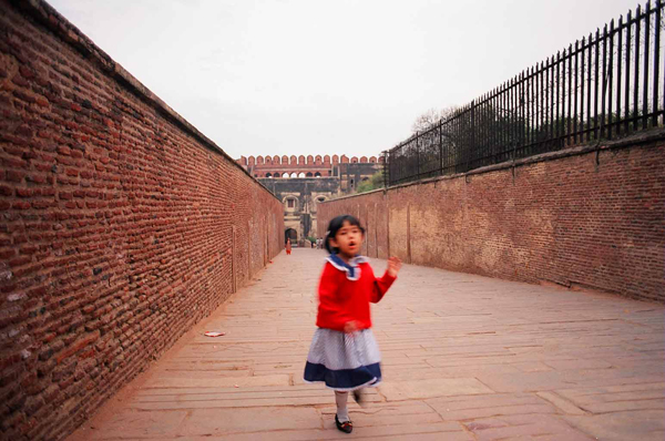 A girl run toward the camera in Agra, India 1996