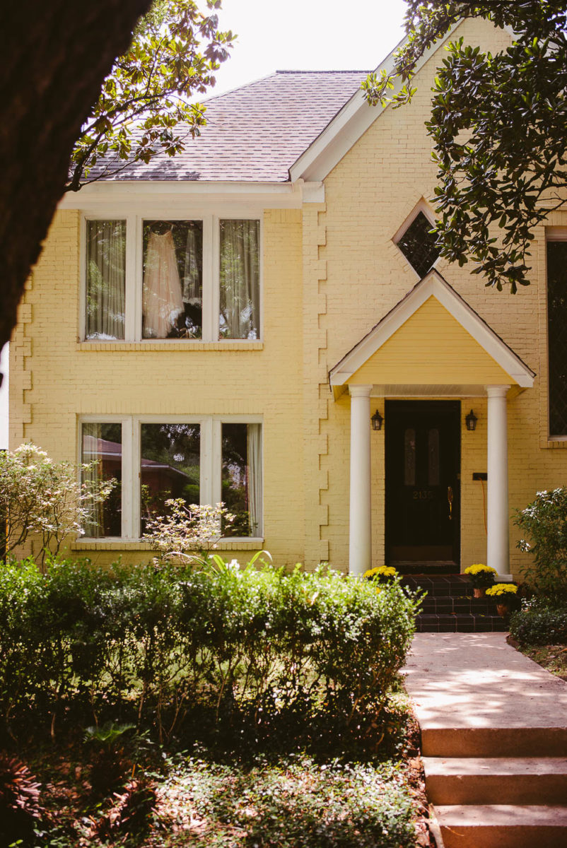 Brides dress hangs at a home in Houston Texas on a hot spring morning-Leica photographer-Philip Thomas Photography