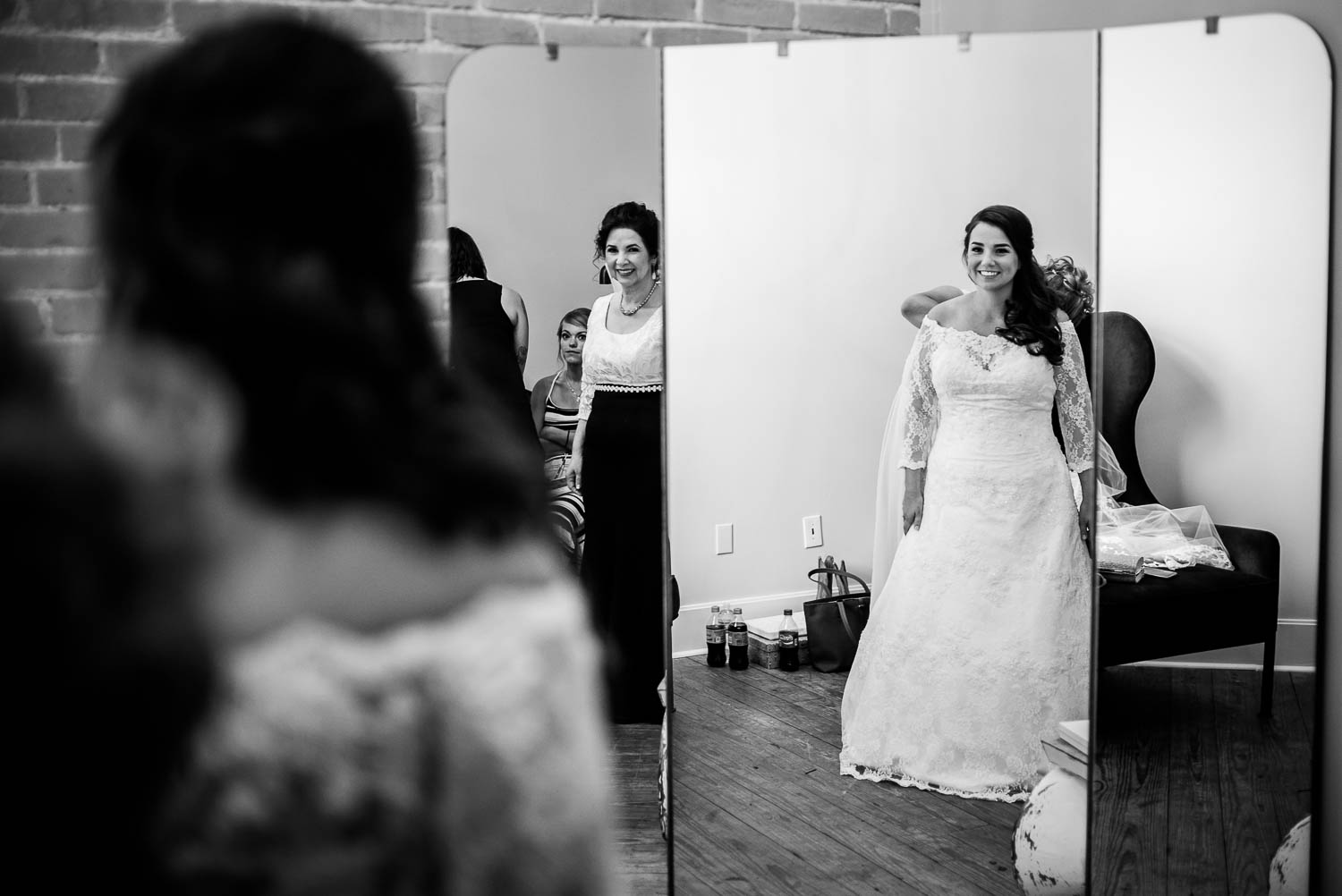 Mother of the bride and Claire look in the large full length mirror at Za Za gardens-Leica photographer-Philip Thomas Photography