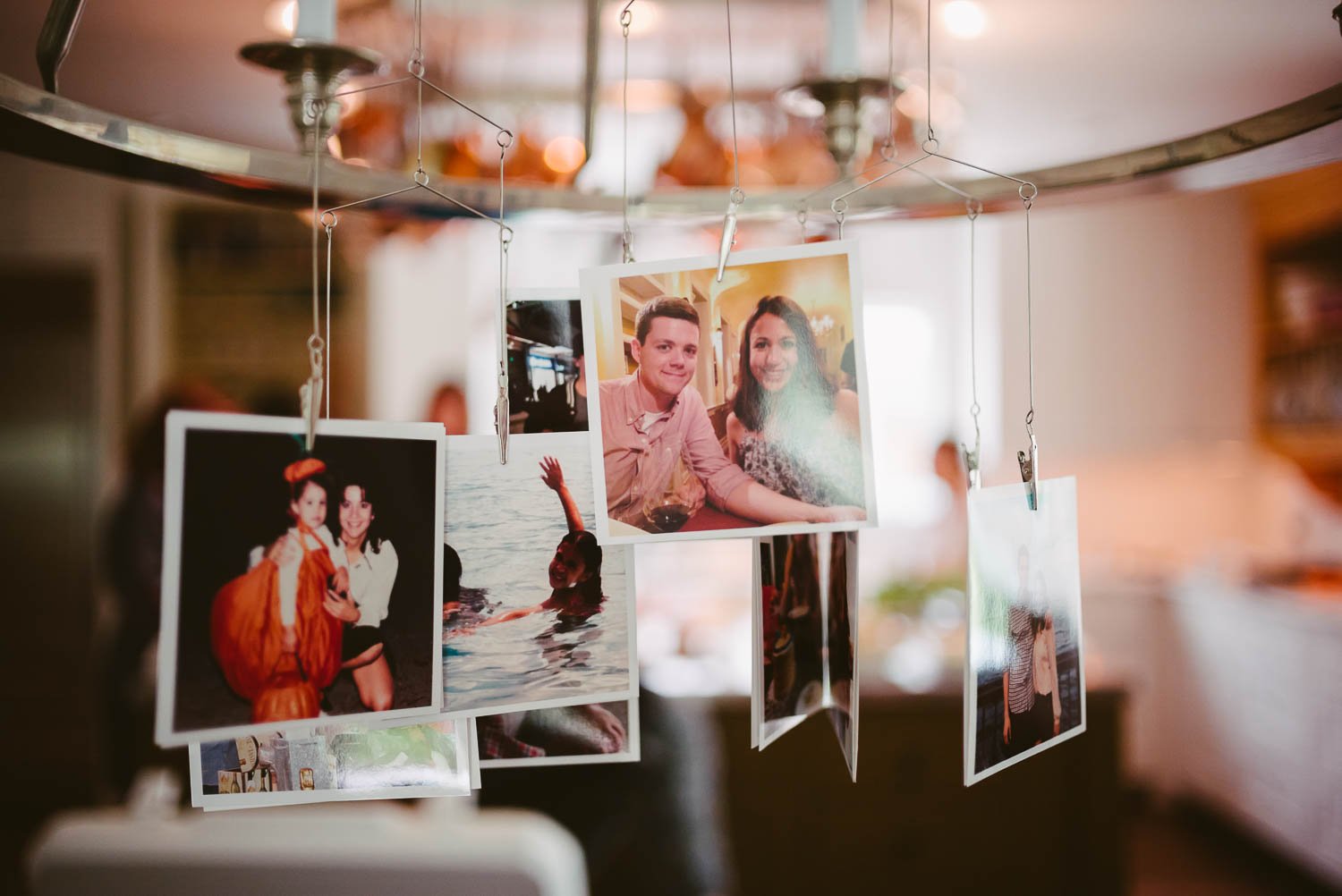 Cute styled snap shots hang on a wedding morning kitchen in Houston Texas-Leica photographer-Philip Thomas Photography