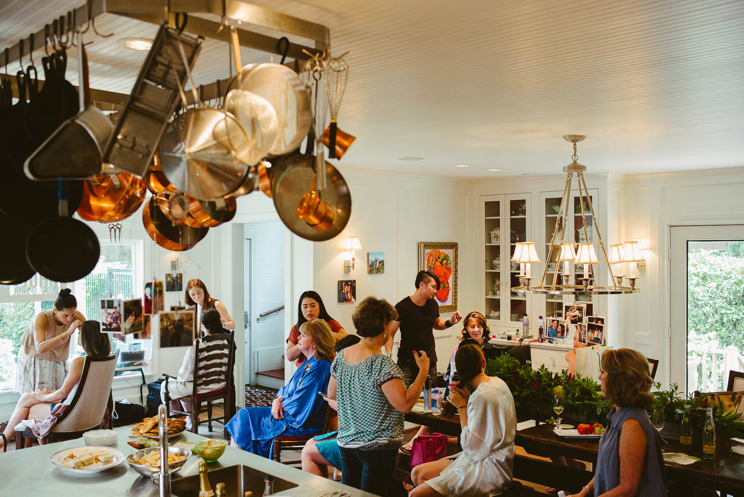 Girls and the makeup team take over the country style kitchen in Houston Texas as bride far left gets ready for her wedding day-Leica photographer-Philip Thomas Photography