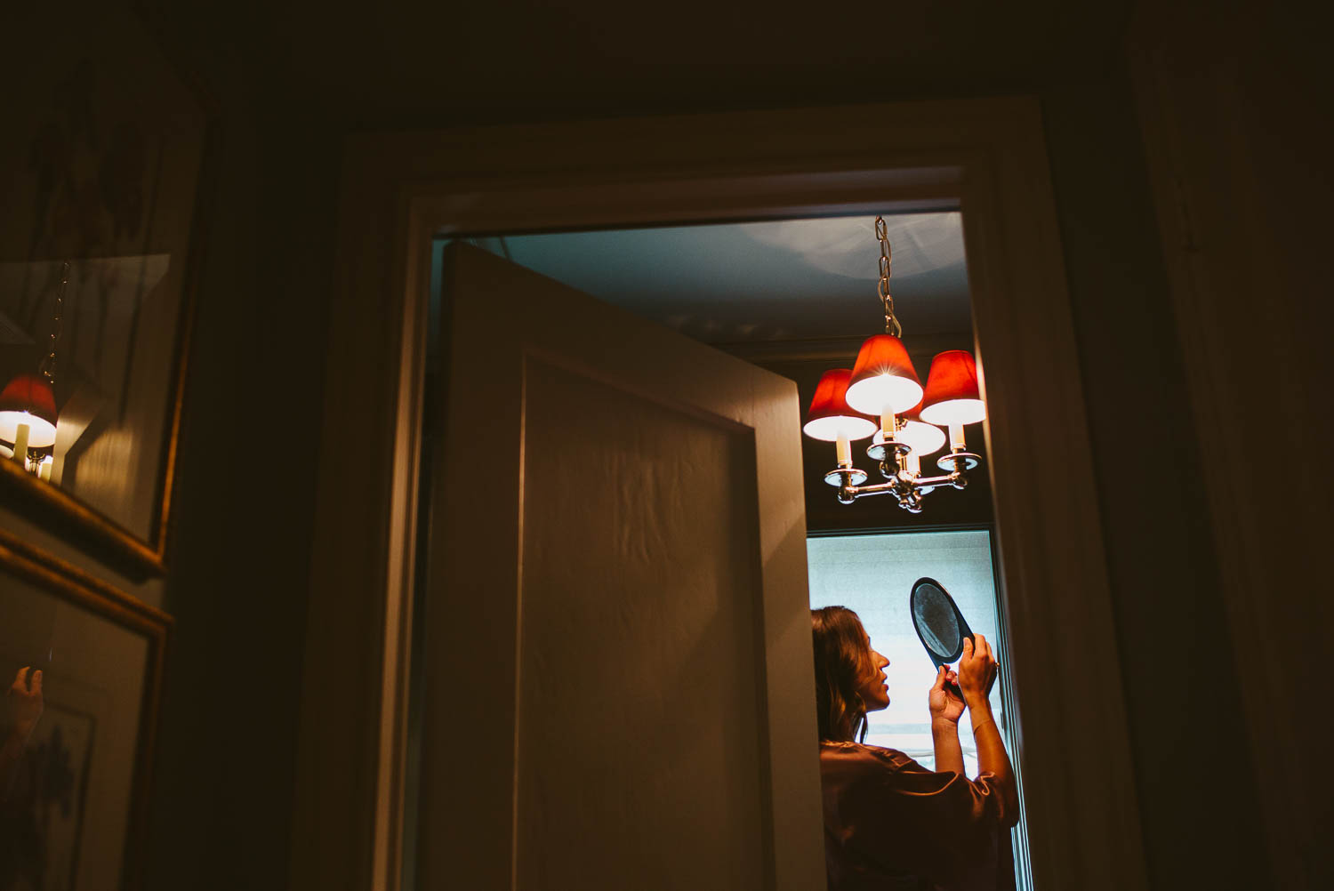 Bride checks the mirror on her wedding morning getting ready Houston Texas-Leica photographer-Philip Thomas Photography