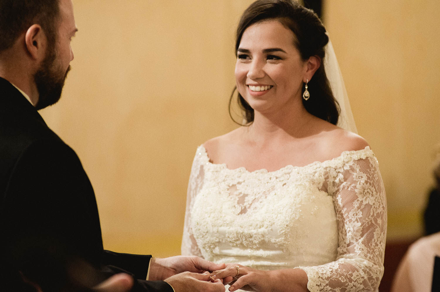 Groom places ring on brides hand at Mission Concepcion Wedding-Leica photographer-Philip Thomas Photography