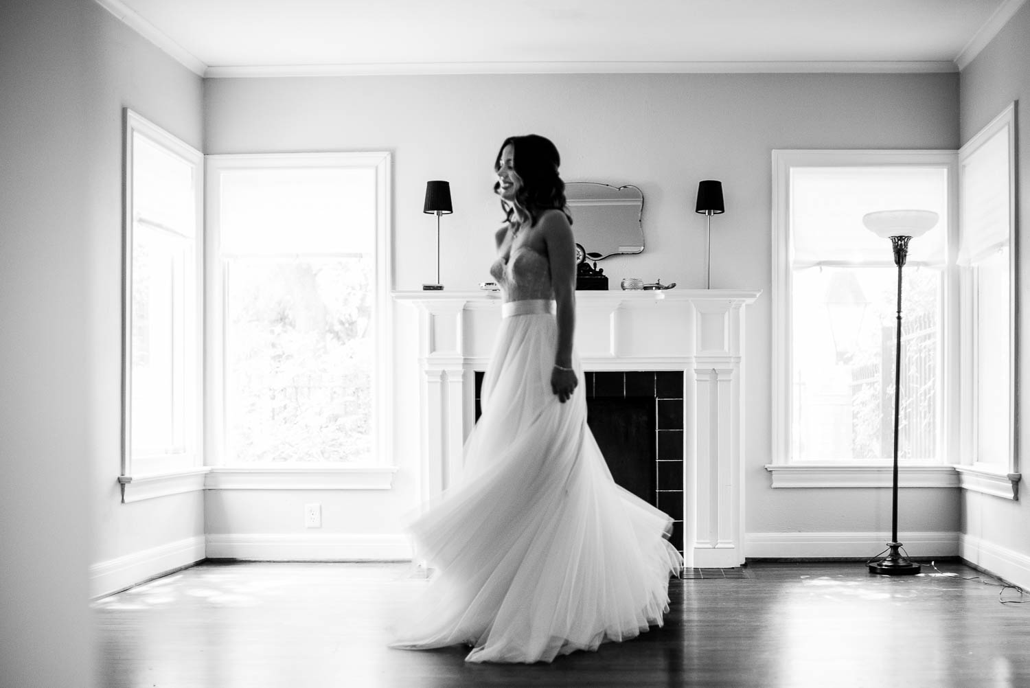 Bride spins and photographed along at Auntie's home with room cleared for a rehearsal dinner party the night prior -Leica photographer-Philip Thomas Photography