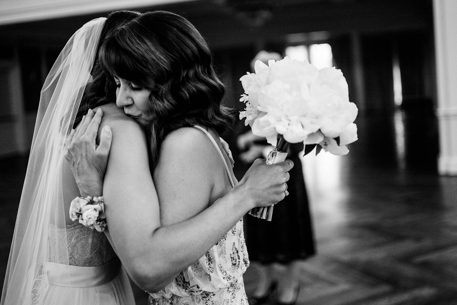 Just married Jessica hugs her mom as she kisses her shoulder River Oaks Country Club-Leica photographer-Philip Thomas Photography