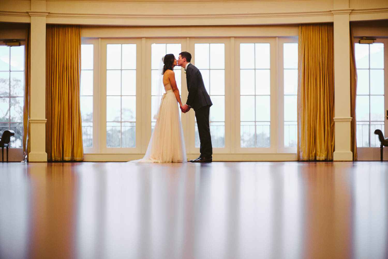 Couple lean in against bright windows River Oaks Country Club-Leica photographer-Philip Thomas Photography