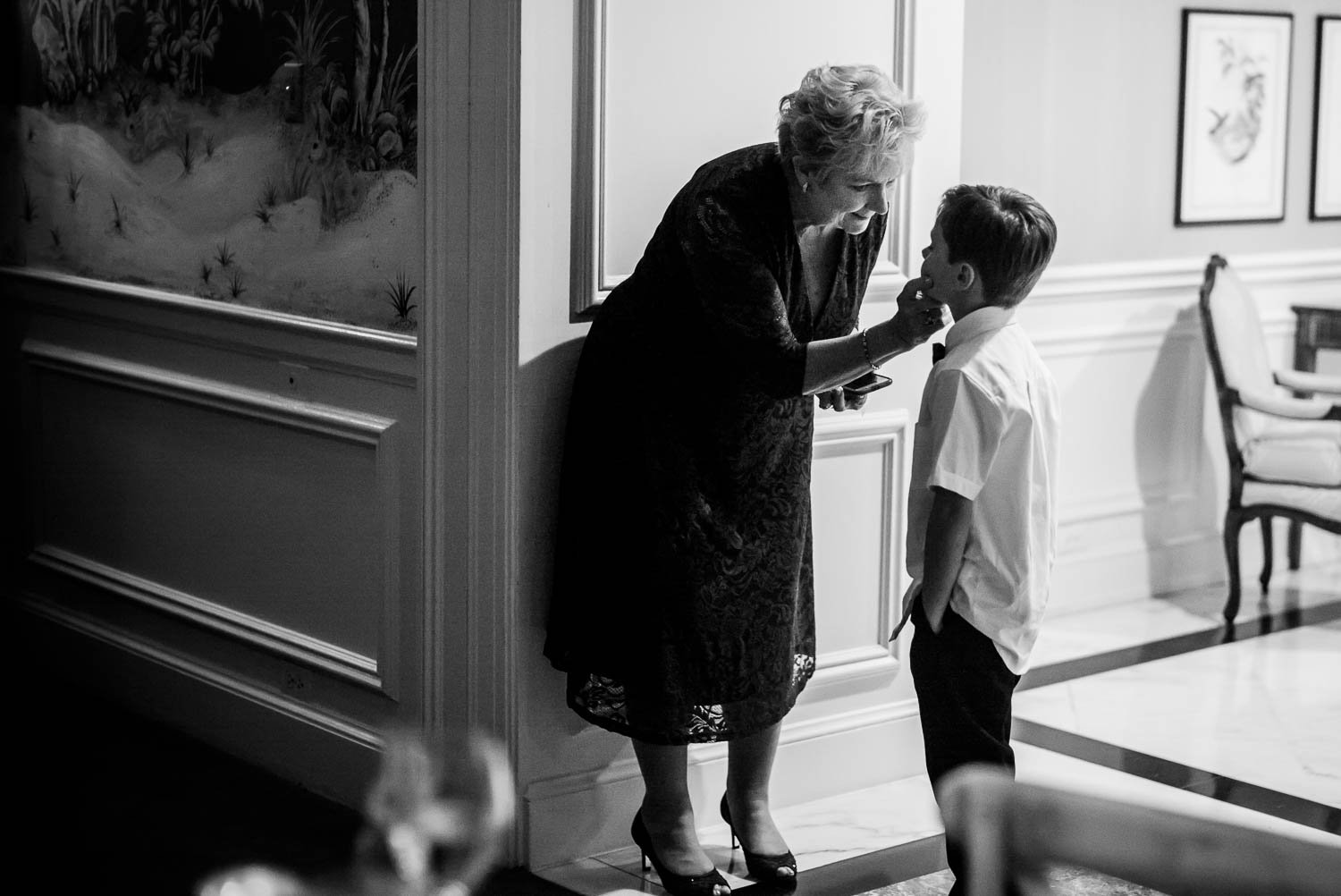 Reception guest tends to little boy at wedding reception River Oaks Country Club-Leica photographer-Philip Thomas Photography