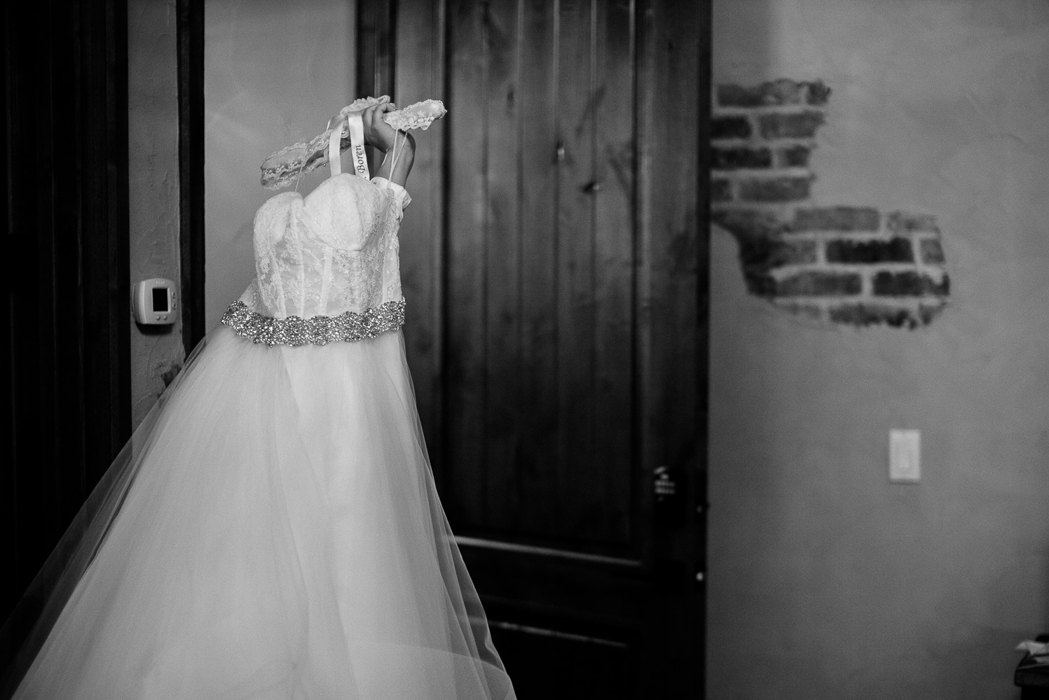 Bridesmaids carries brides wedding gown at Chandelier of Gruene-08