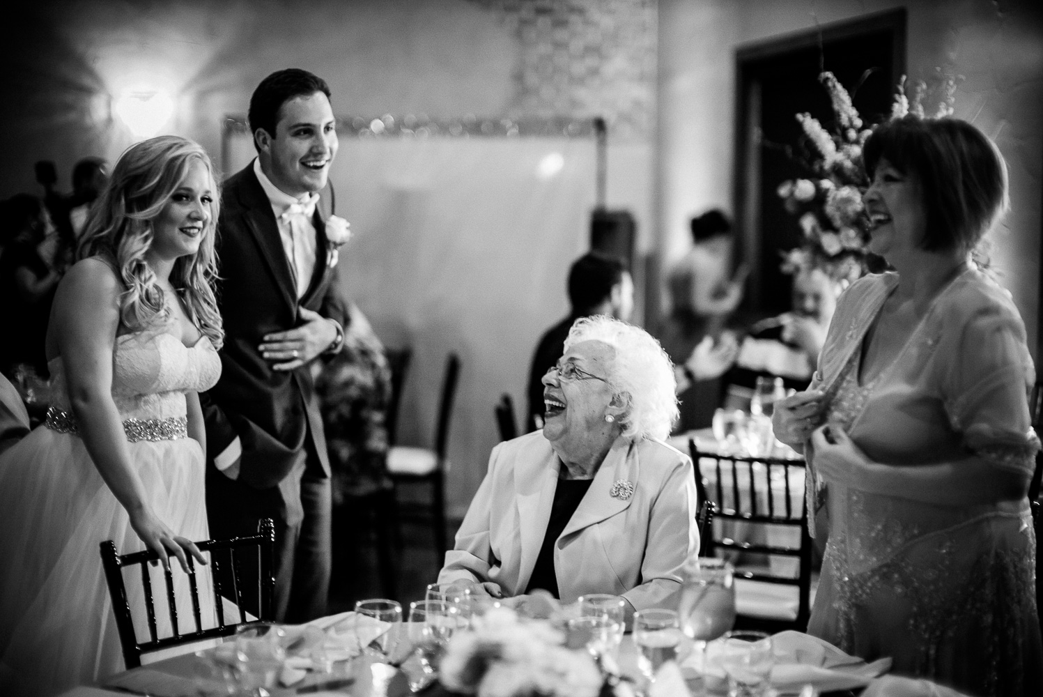 Jokes are shared between guests and bride and groom Chandelier of Gruene Wedding Reception-37