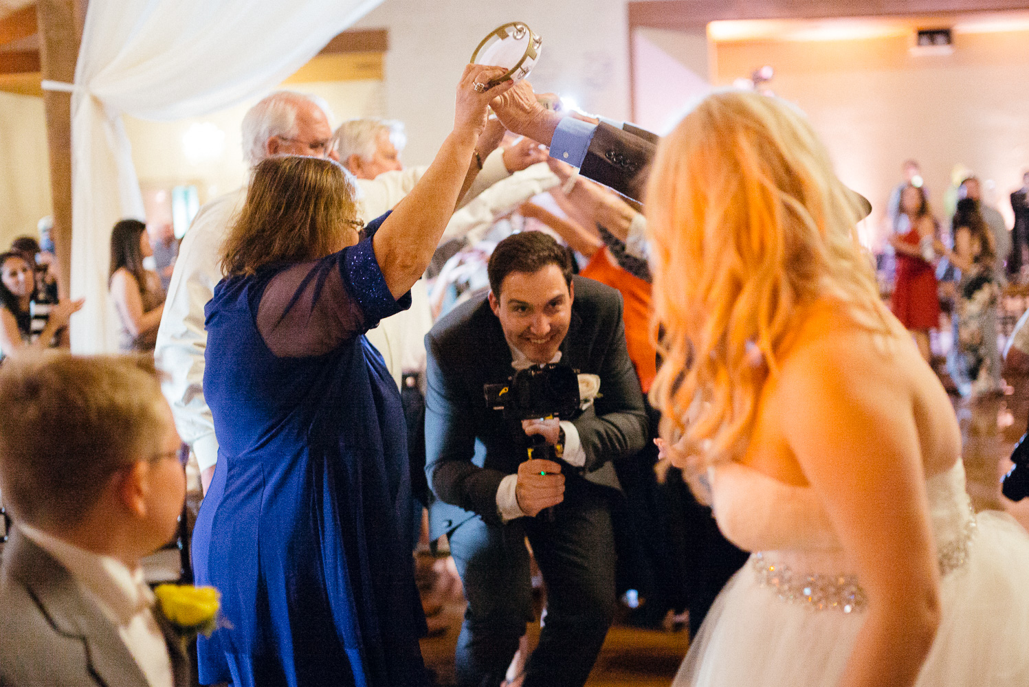 During the Grand March the groom appears holding a videocamera Chandelier of Gruene Wedding Reception-45