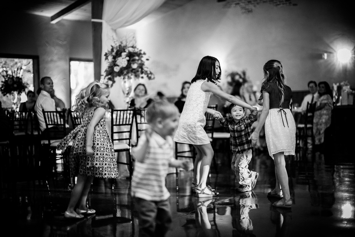 Kids play together on the dance floor at Chandelier of Gruene Wedding Reception-50