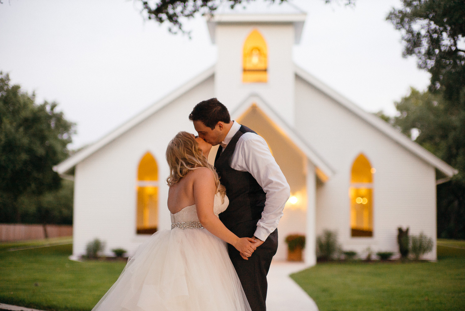 Couple kiss at Chandelier of Gruene Wedding Reception-53