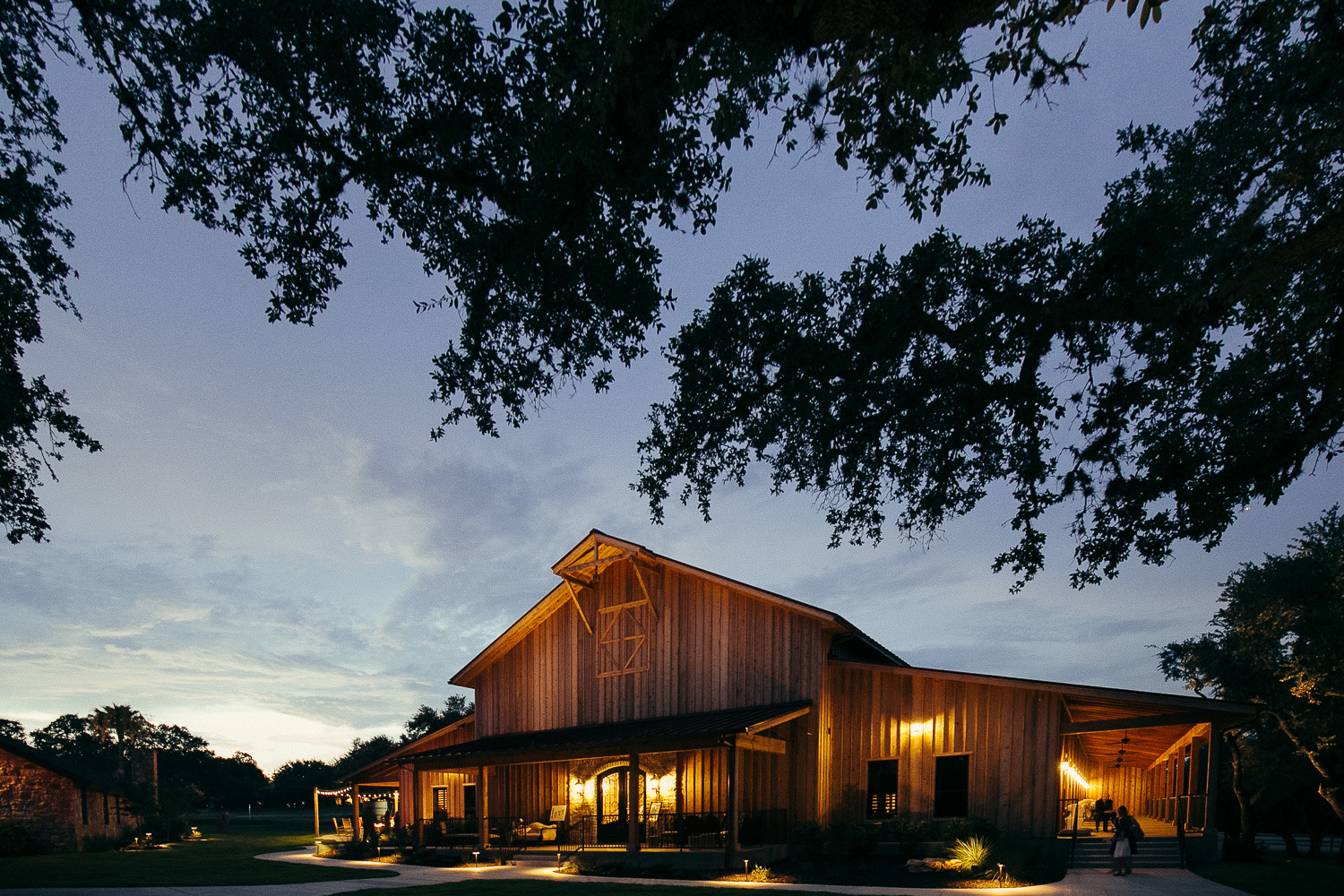 Wide dusk shot of Chandelier of Gruene Wedding Reception-56