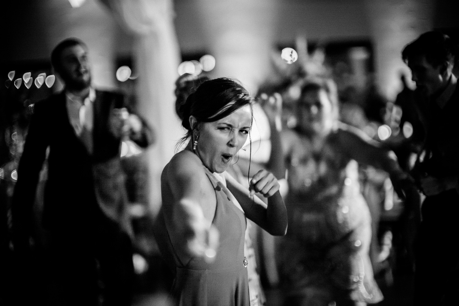 Bridesmaids shoots a look at the camera Chandelier of Gruene Wedding Reception-57