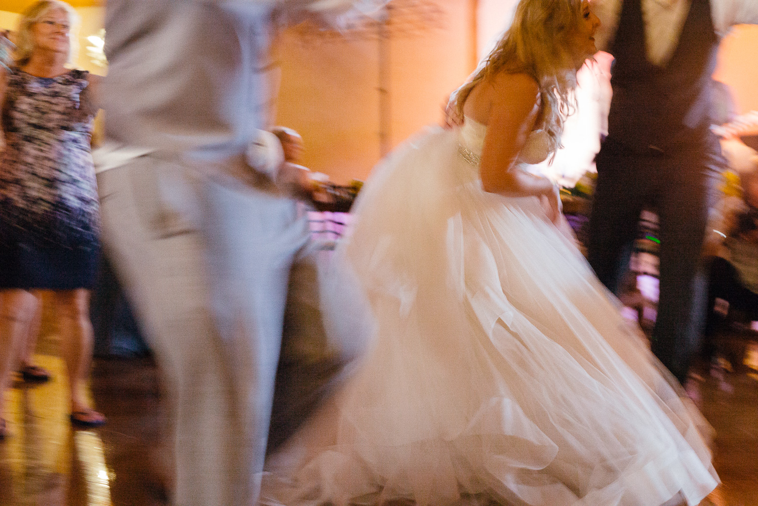 Brides dress on reception floor captured dragging shutter speed Chandelier of Gruene Wedding Reception-62