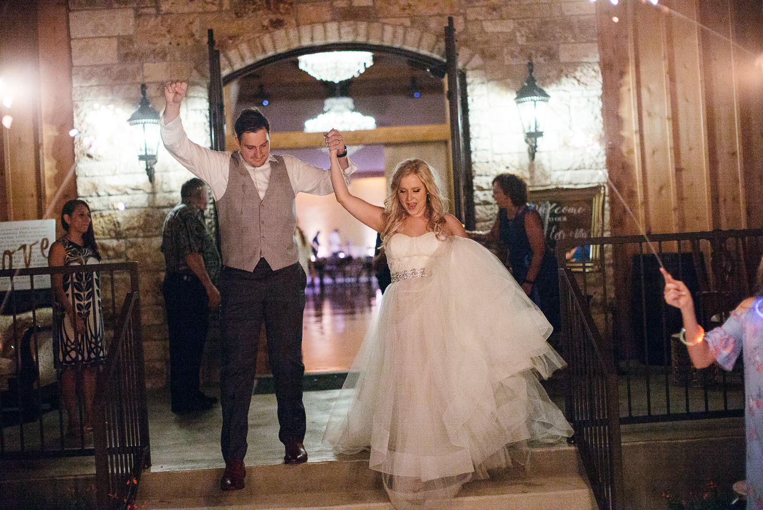 The getaway for couple as groom punches the air at Chandelier of Gruene Wedding Reception-68