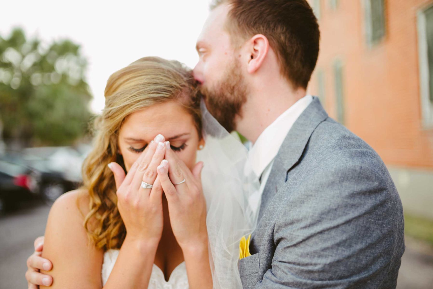 Emotional image showing bride and groom moments after getting married and calling her grandfather who could not attend wedding. Galveston, Texas photographed with a Leica M(240).