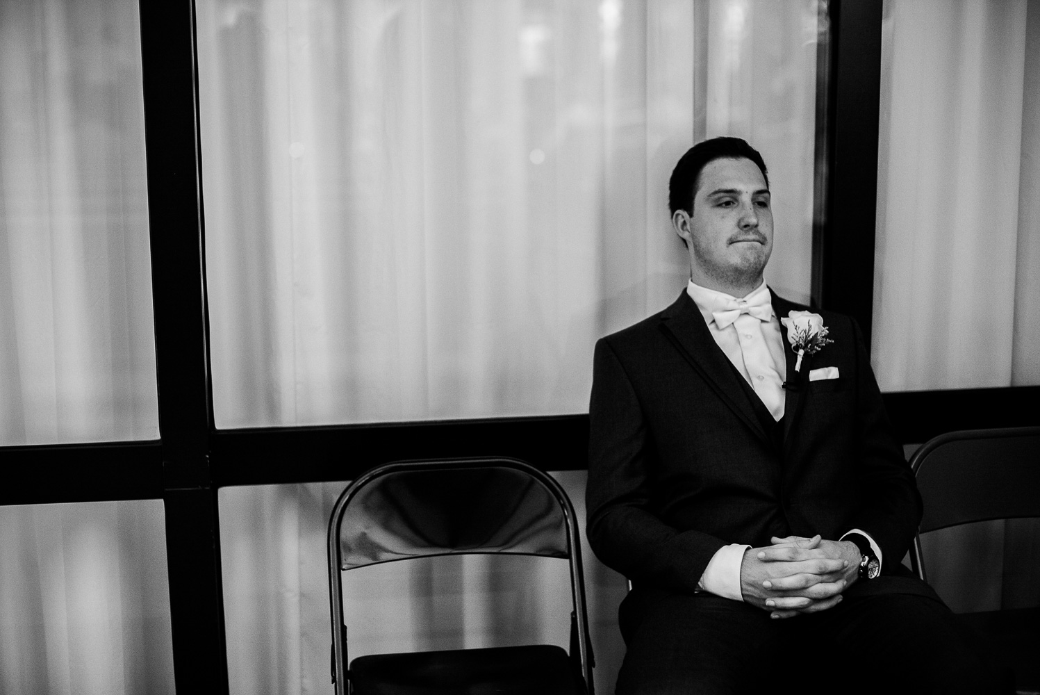 Groom reflects in a quiet moment at Our Lady of Perpetual Help Wedding-16
