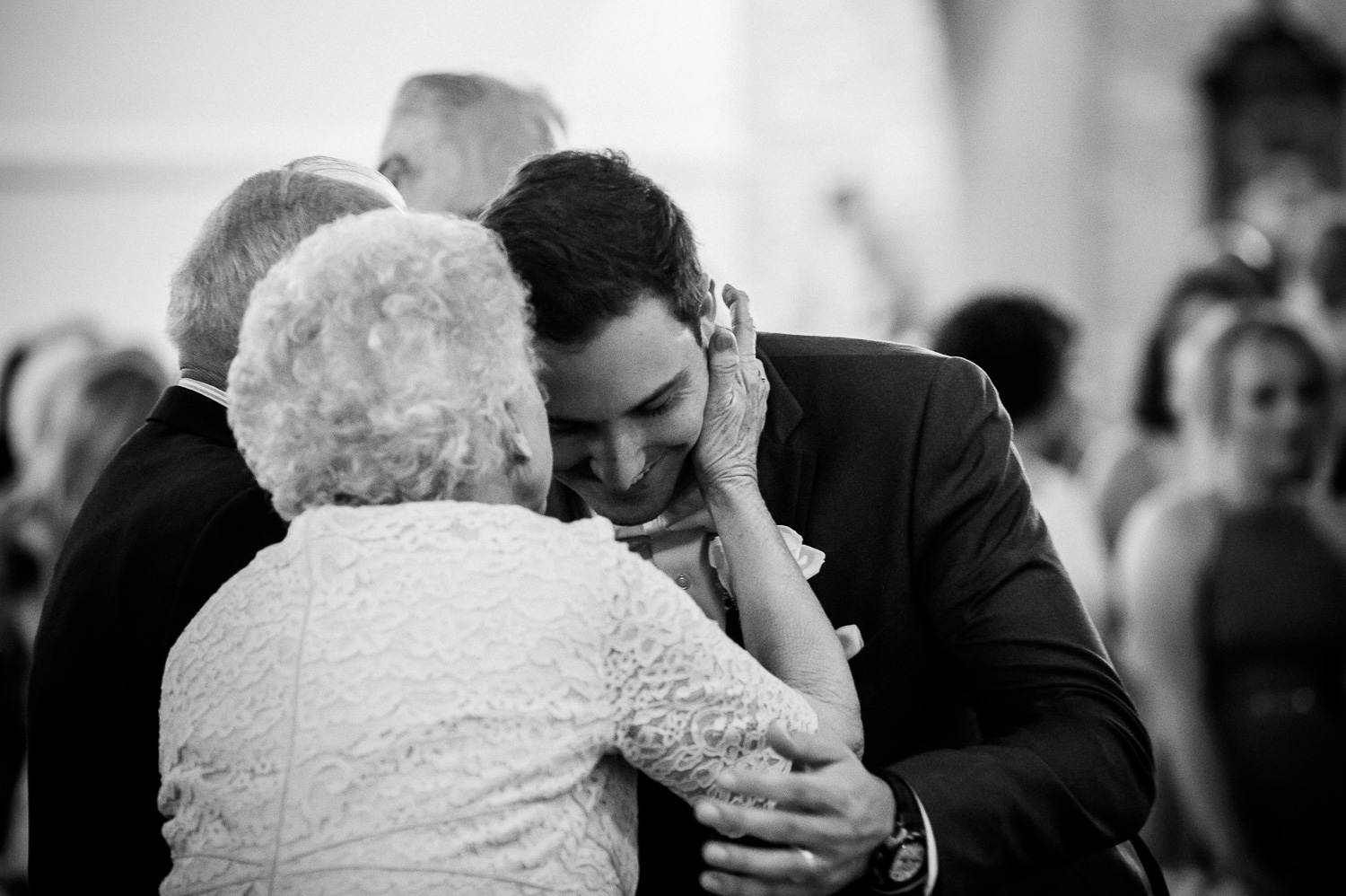 Grandmother kisses grandson at Our Lady of Perpetual Help Wedding-20