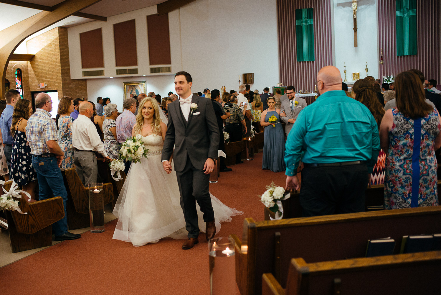 Just married couple walk down the aisle Our Lady of Perpetual Help Wedding-22