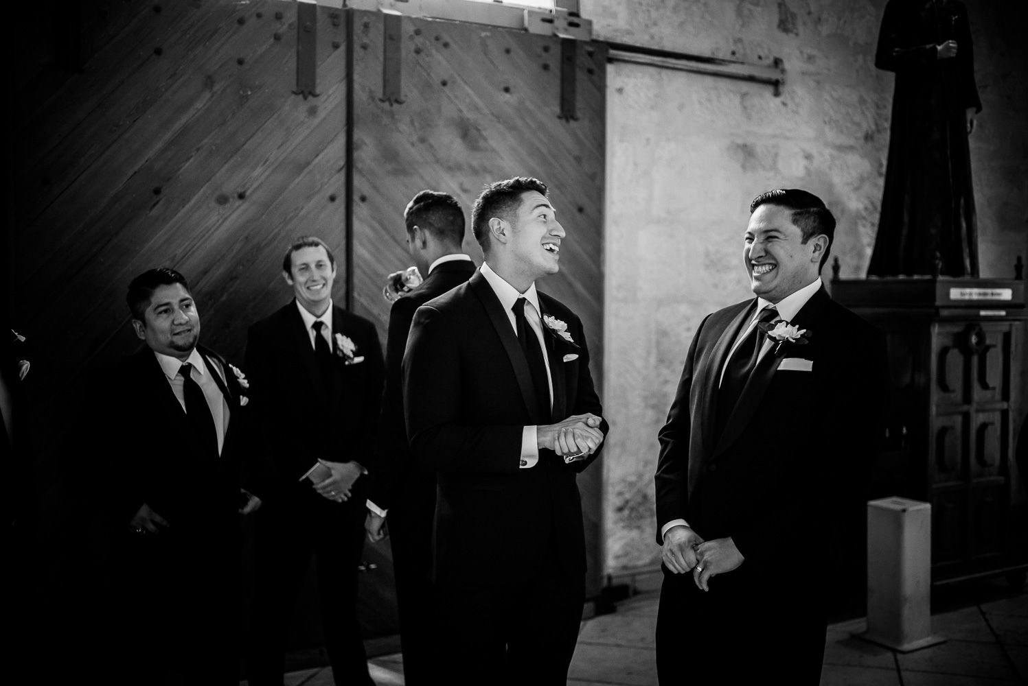 Friends and groomsmen share a light hearted moment before the wedding ceremony San Fernando Cathedral Wedding-18