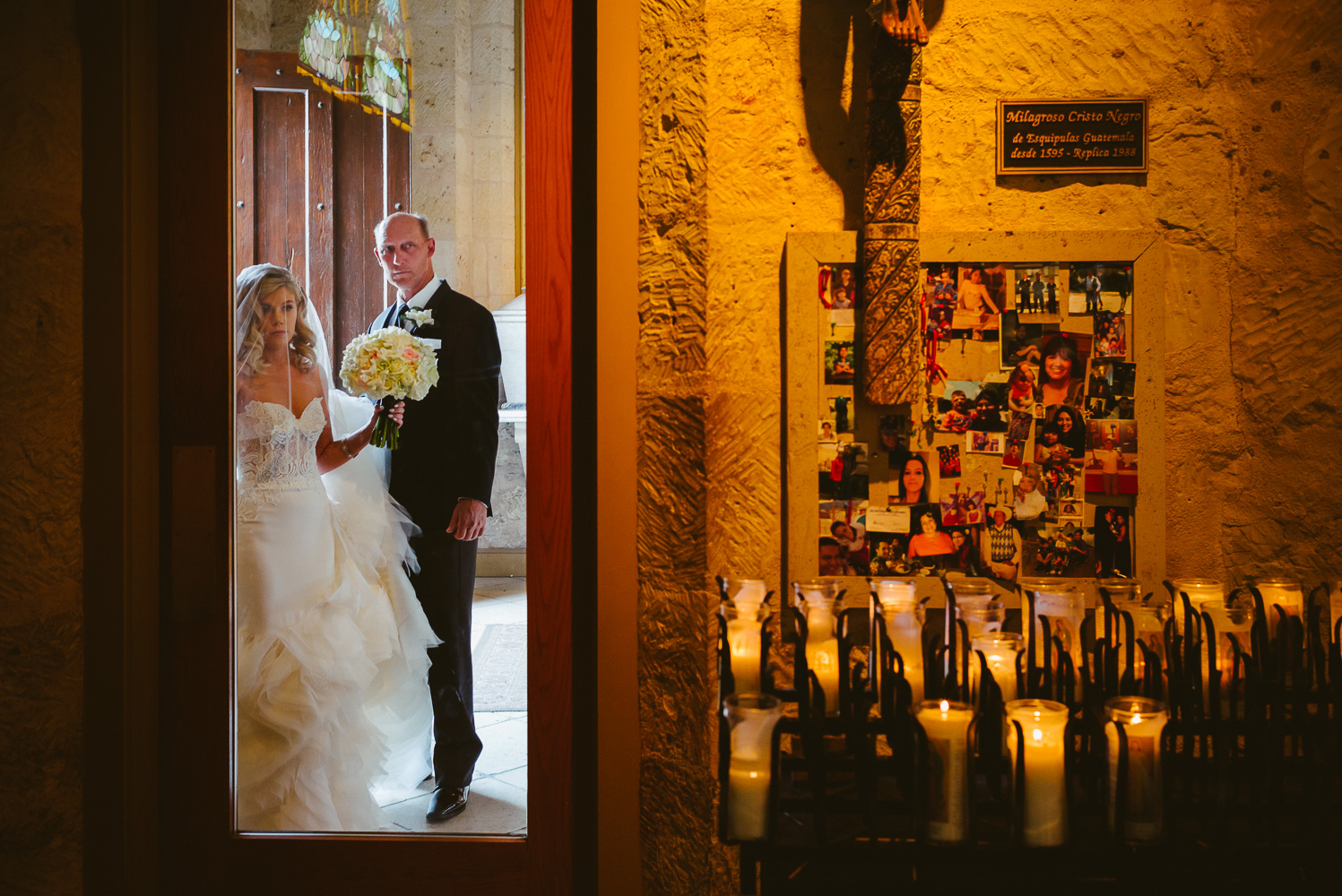 Bride and father peer through a glass door awaiting the signal to enter the wedding ceremony San Fernando Cathedral Wedding-19