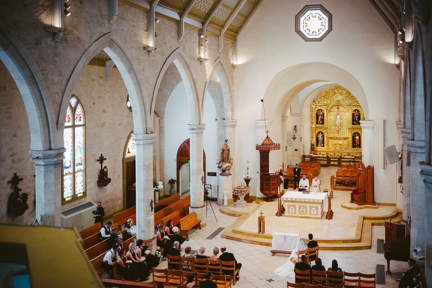 A wide shot captured from a tall winding staircase wedding ceremony San Fernando Cathedral Wedding-22