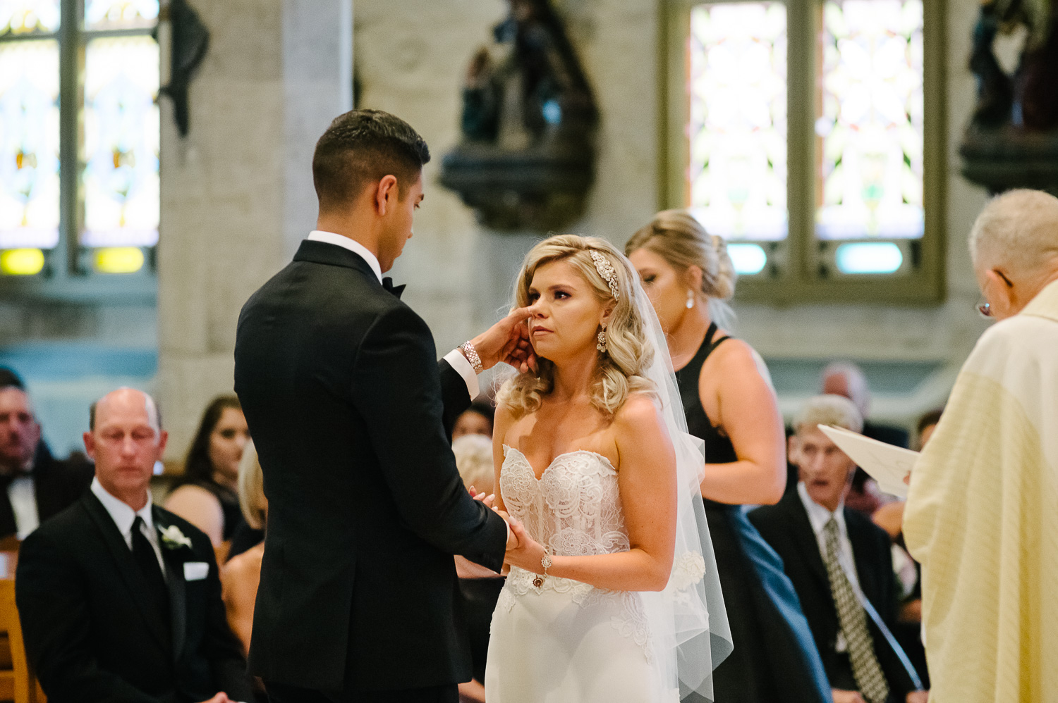 Groom wipes tear from brides eye during vows at San Fernando Cathedral Wedding-23