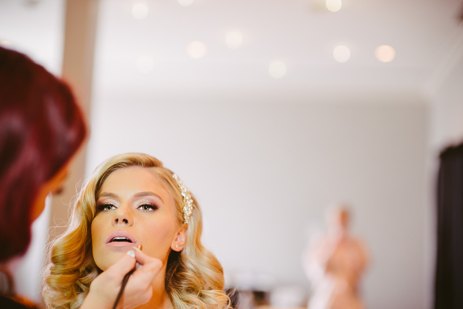 Bride as lip stick applied on her wedding morning preperation St Anthony Hotel Wedding-05