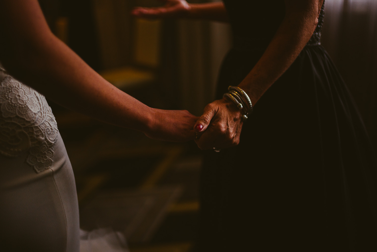 Bride and mother hold hands at St Anthony Hotel Wedding-10