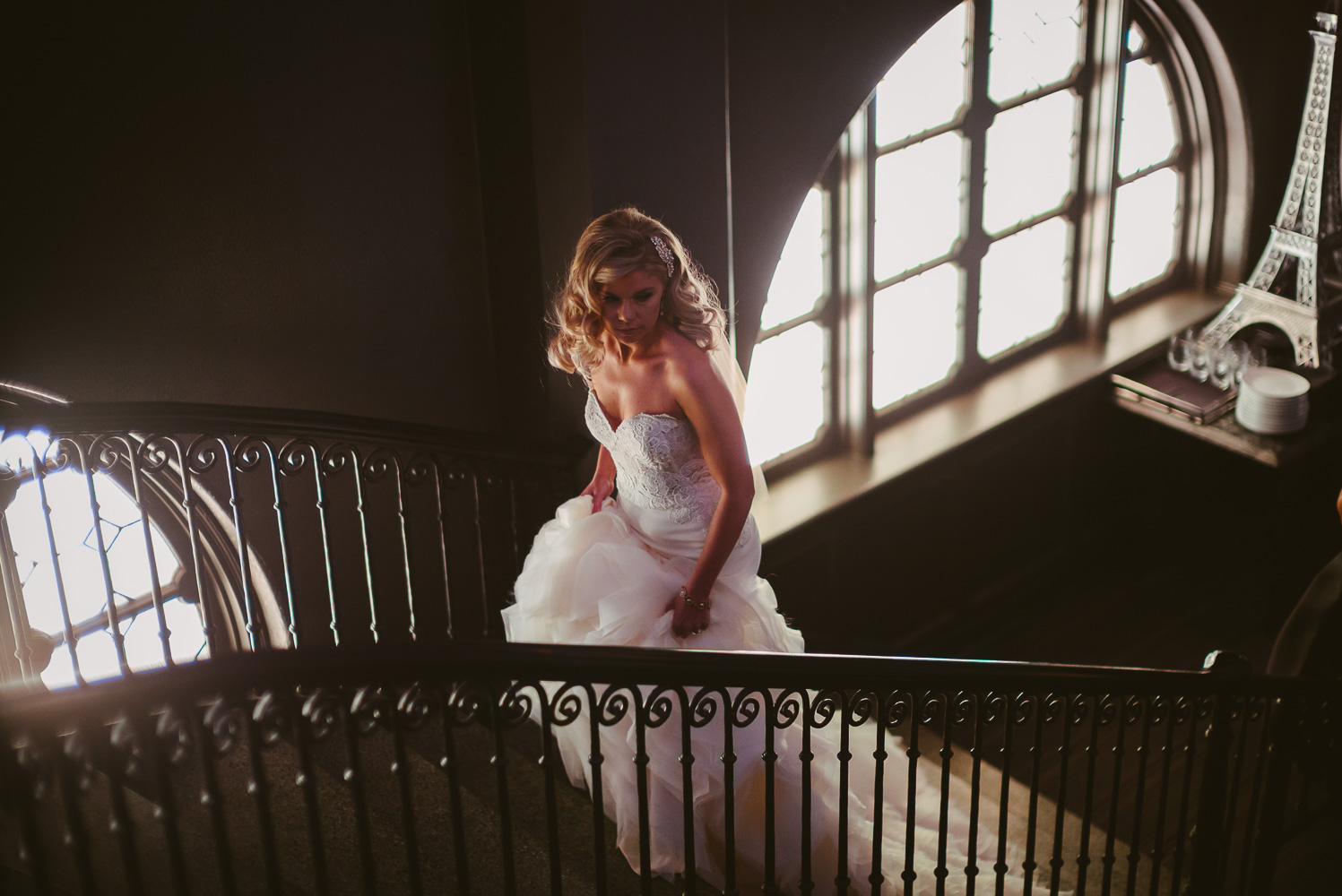 Bride ascends staircase at Haunt Lounge St Anthony Hotel Wedding-12