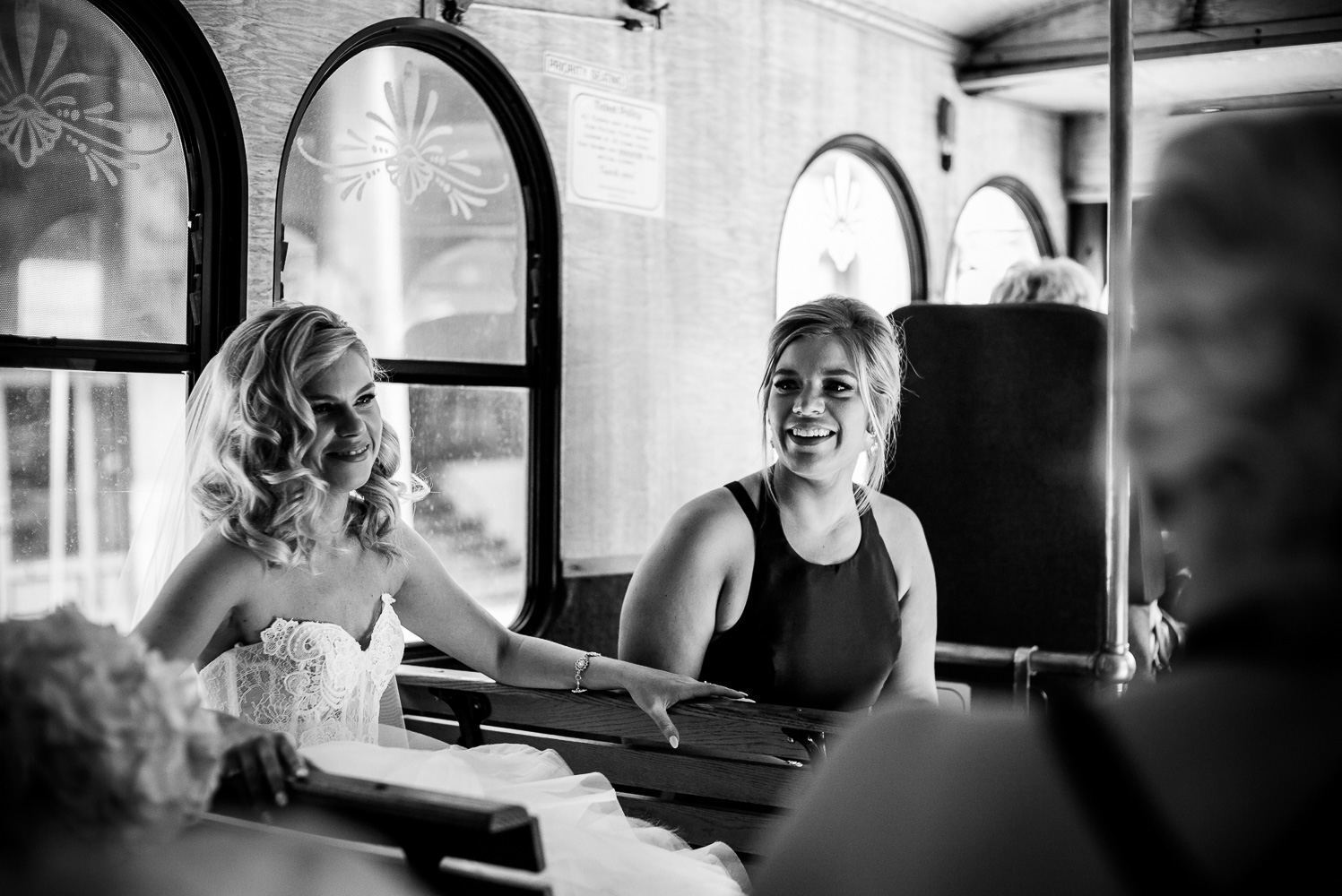 Bride and sister share a moment on trolley taking them from St Anthony to San Fernando Cathedral during a very hot humid July wedding