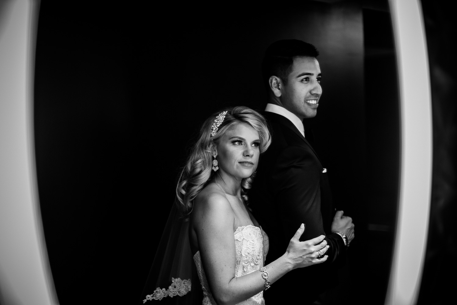 Photographed in the mens restrooms show the couple in a mirror St. Anthony Hotel San Antonio Wedding Reception-36