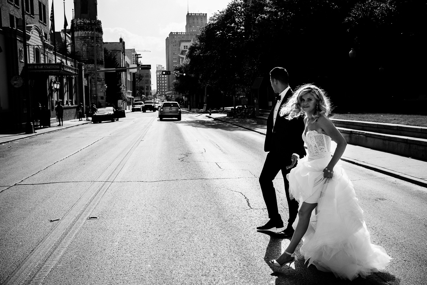 Sunset The couple cross the street toward St. Anthony Hotel San Antonio Wedding Reception-37