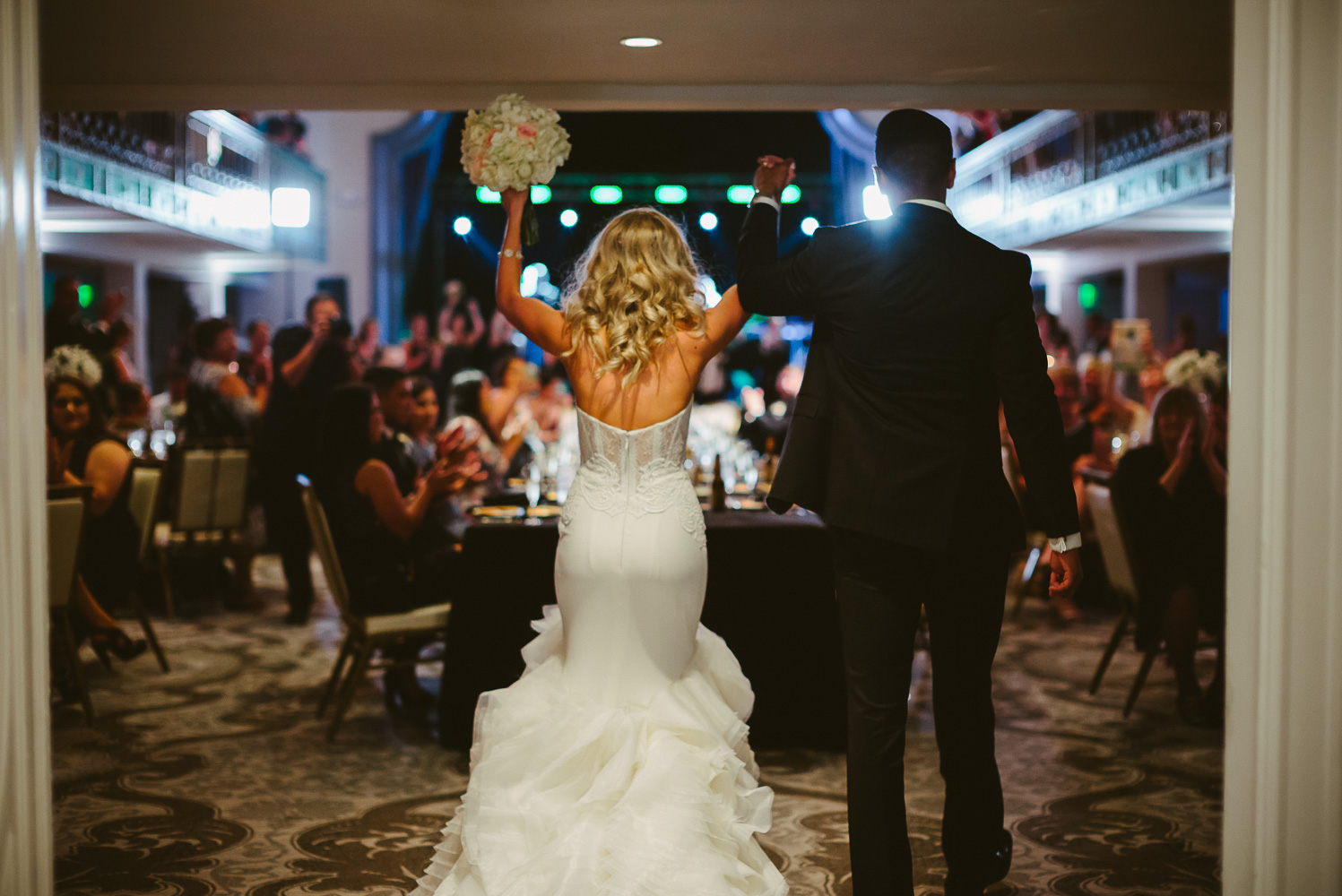 Couple arrive to a roar of approval at wedding reception St. Anthony Hotel San Antonio Wedding Reception-40