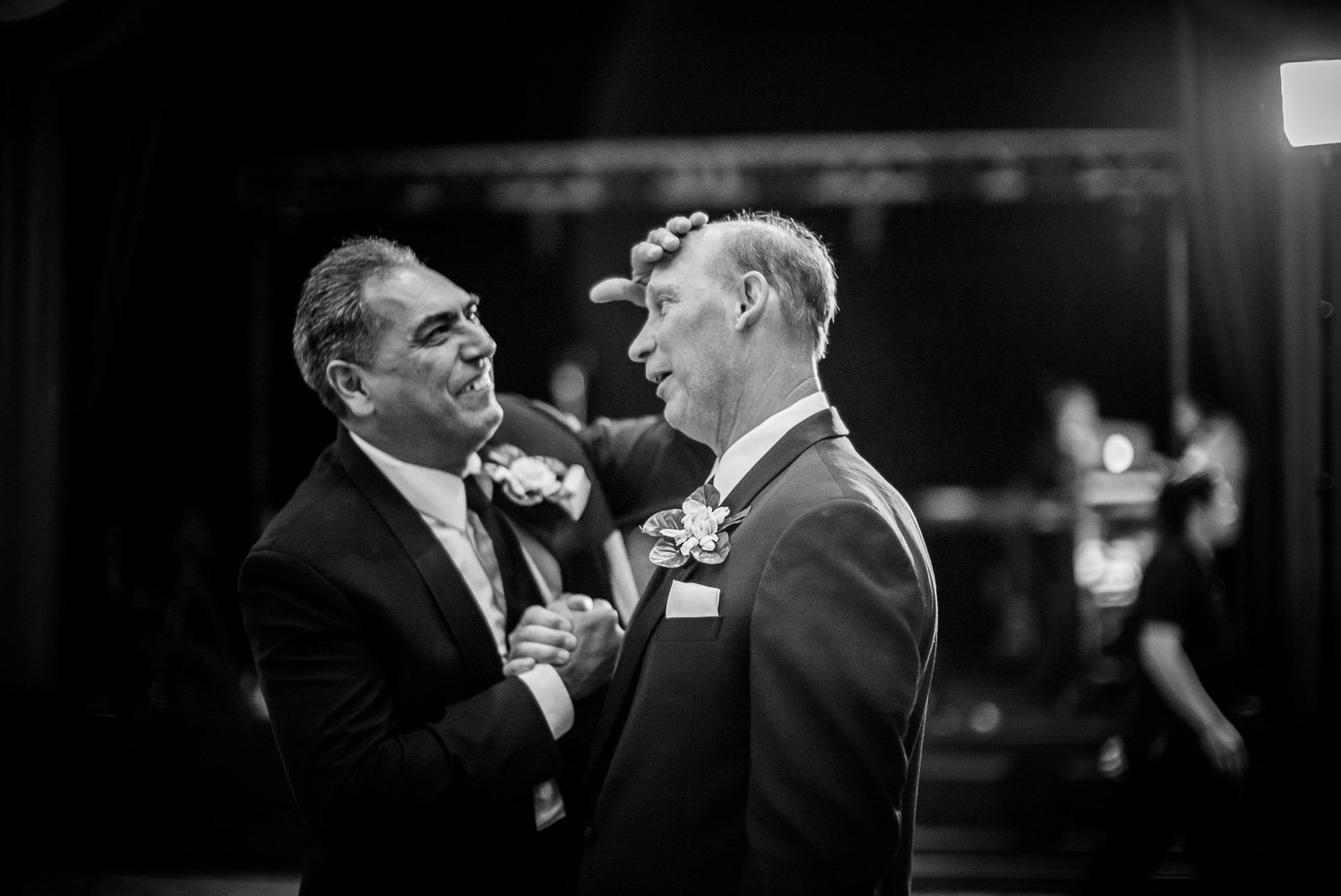 Two fathers share a light hearted moment during speeches St. Anthony Hotel San Antonio Wedding Reception-42
