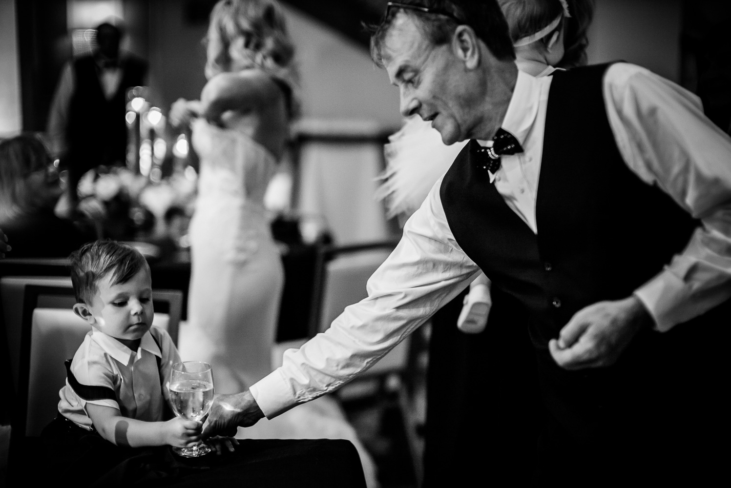 Family member plays with a young boy St. Anthony Hotel San Antonio Wedding Reception-44