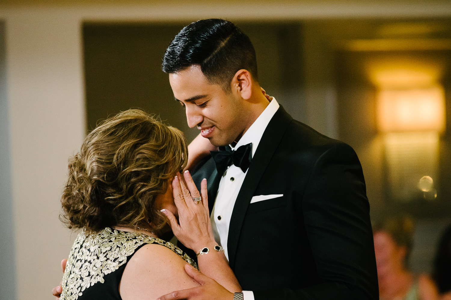Mother of the groom wipes a tear during the first dance St. Anthony Hotel San Antonio Wedding Reception-46