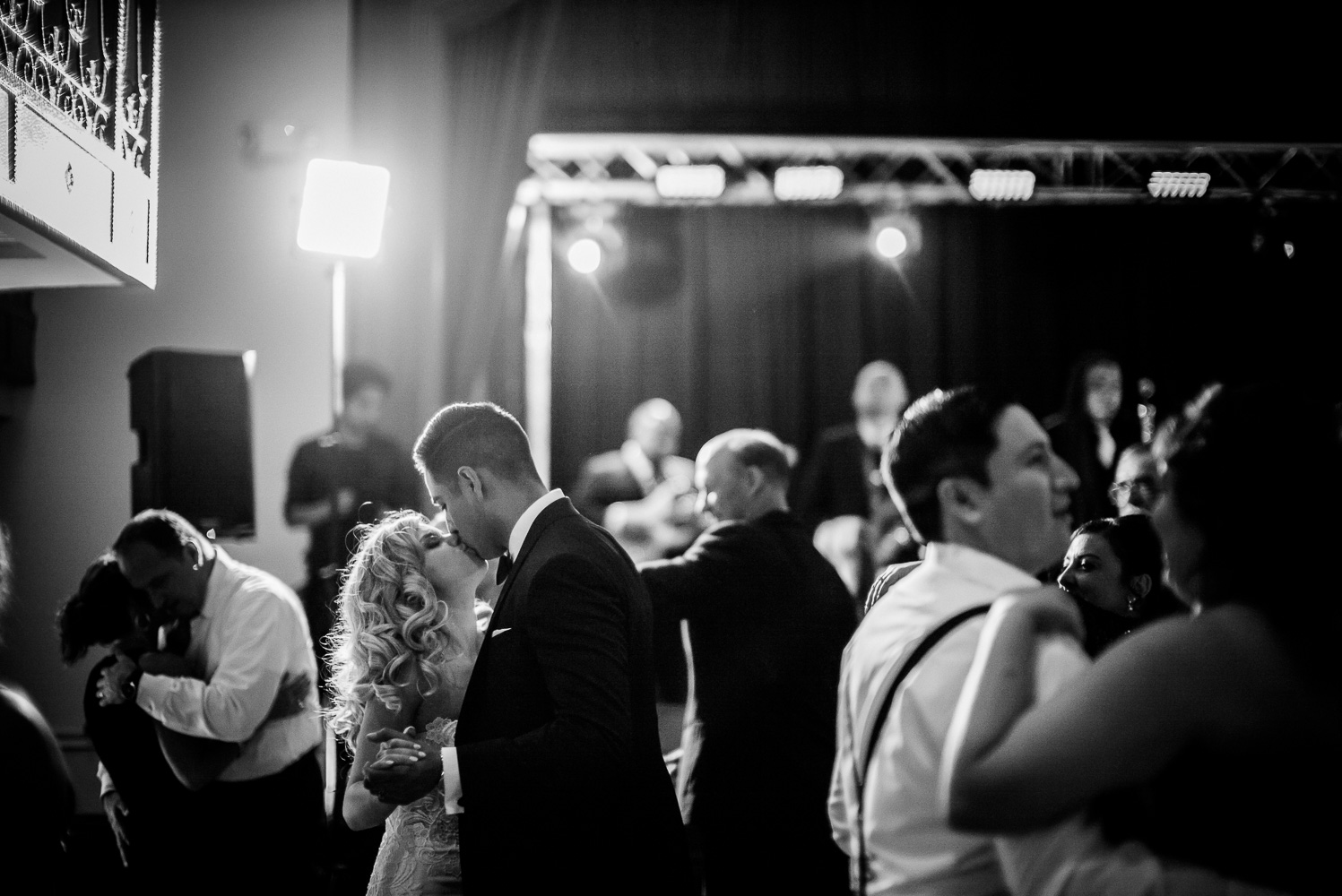 Married couple Nathan and Brittaney share a quick kiss on reception floor St. Anthony Hotel San Antonio Wedding Reception-49