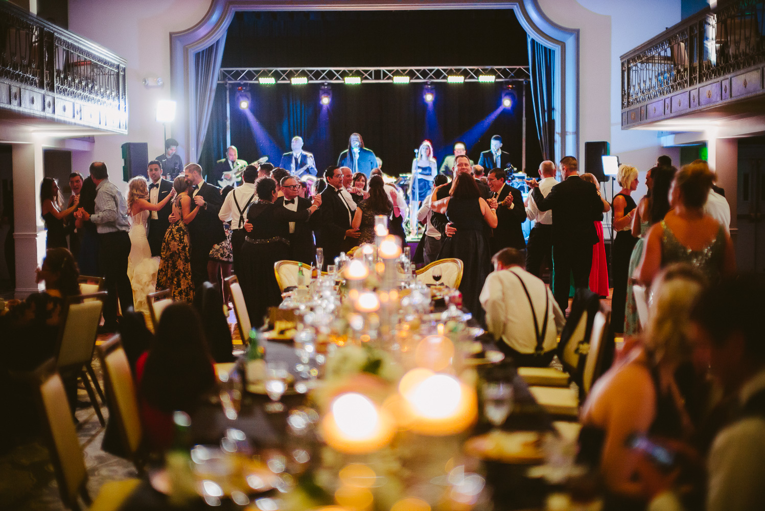 Wide color shot of center bridal party tables and guests in the background St. Anthony Hotel San Antonio Wedding Reception-51