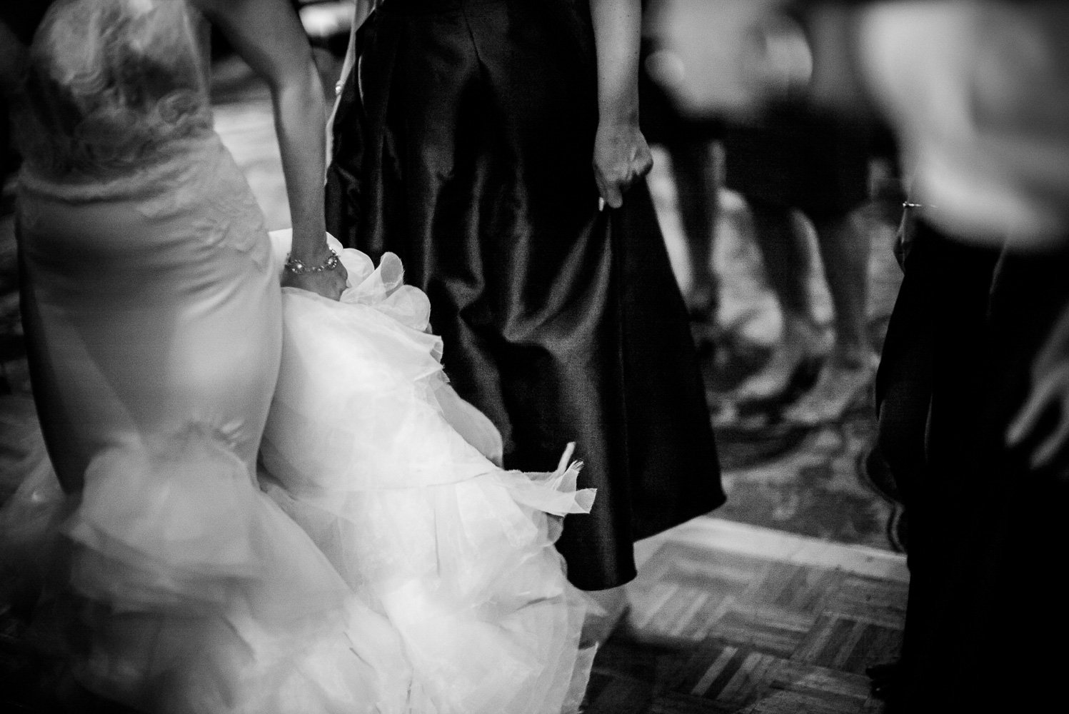 Bride clutches her wedding dress train at St. Anthony Hotel San Antonio Wedding Reception-52