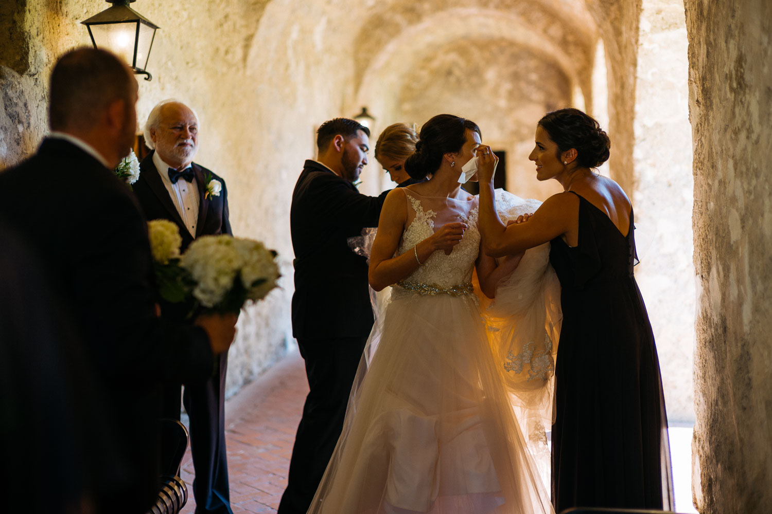 Moments before walking down the aisle with her father, Deedra's eyes are wiped by her maid of honor Mission Concepcion Wedding