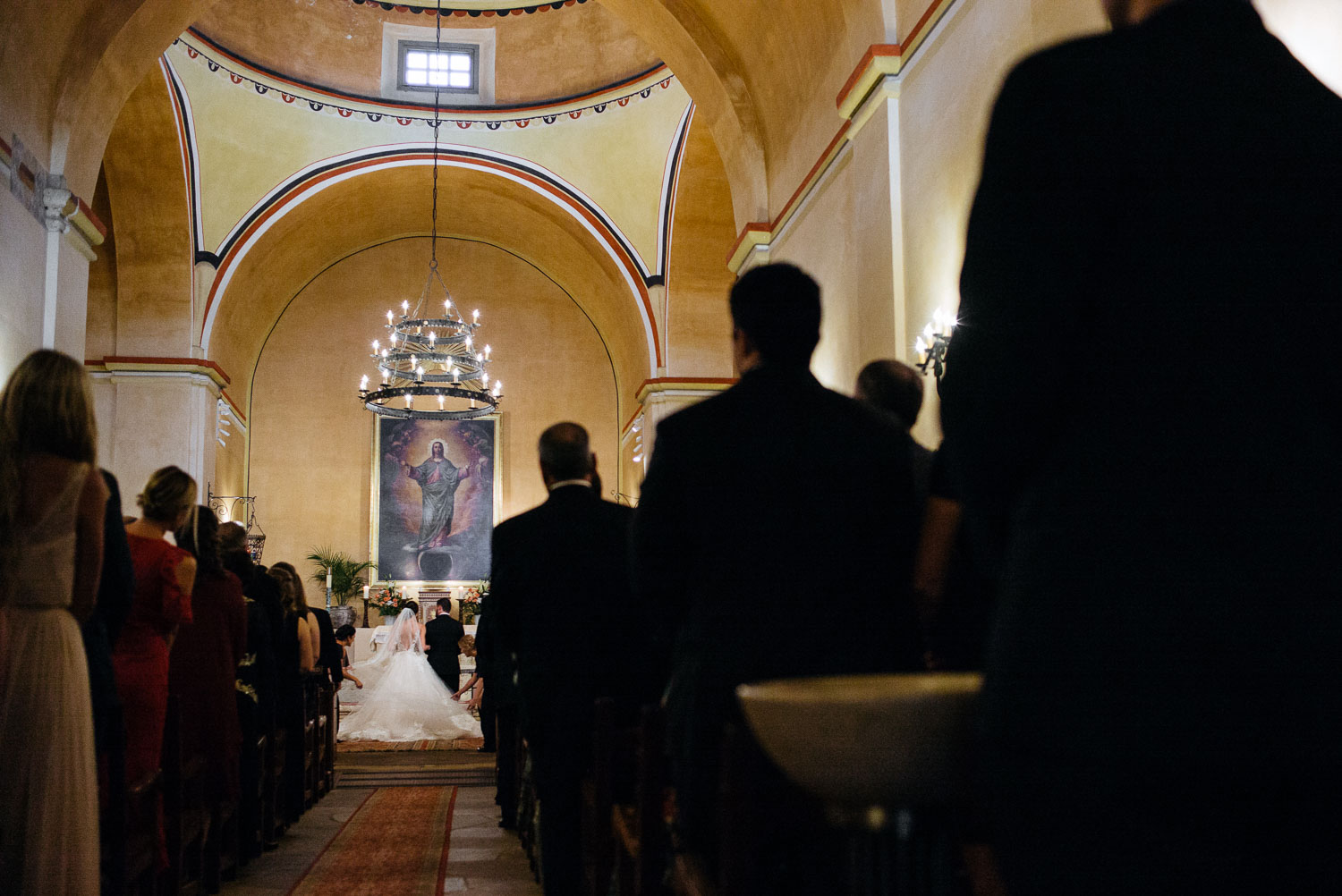 Couple join hands as wedding ceremony starts at Mission Concepcion Wedding